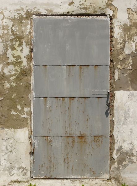 Grey metal door with spots of rust.